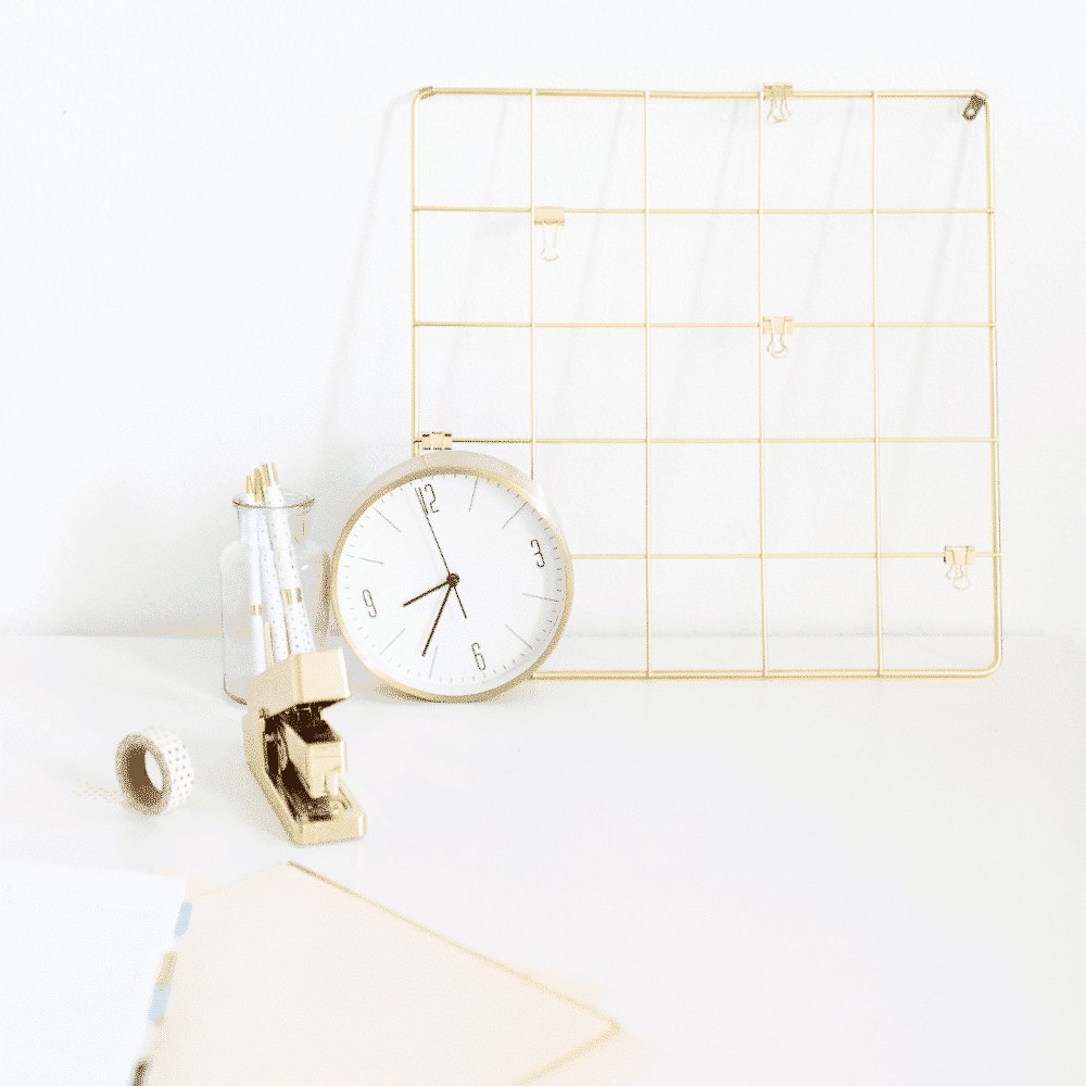 desk for creatives with gold details like a clock