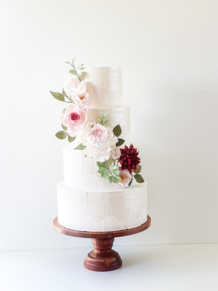 Sugar Flower cascade with peonies, roses, dahlias, and greenery in blush and burgundy colors