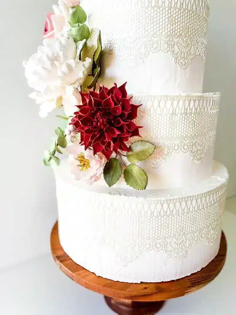 Close up of burgundy dahlia Sugar flower on a wedding cake cascade