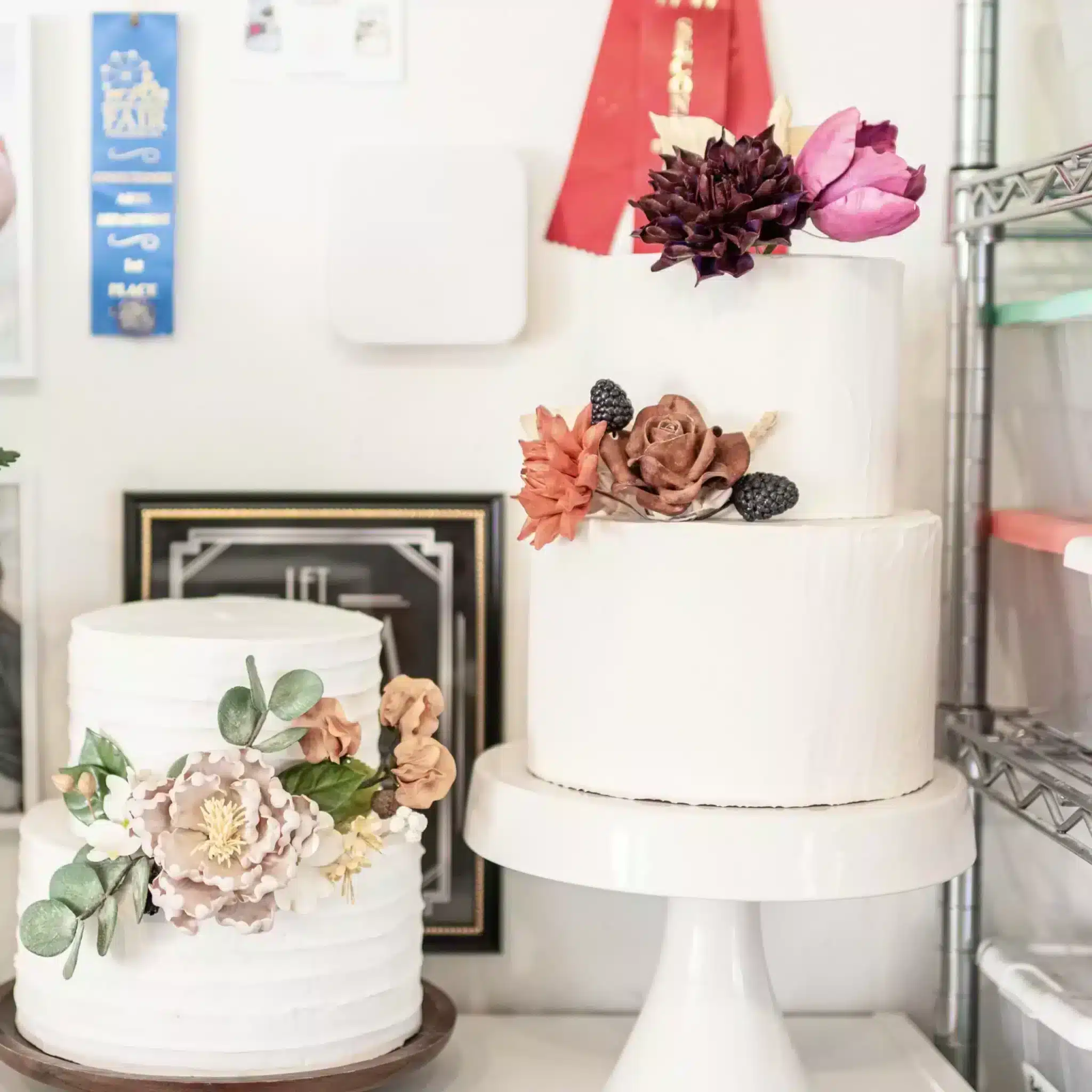 Two display cakes decorated with sugar flowers