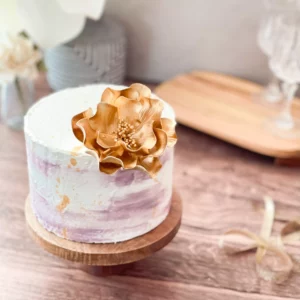 gold open rose sugar flower on a 6 inch cake