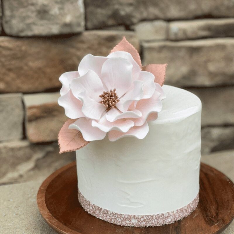 blush and rose gold open rose sugar flower with 3 rose leaves