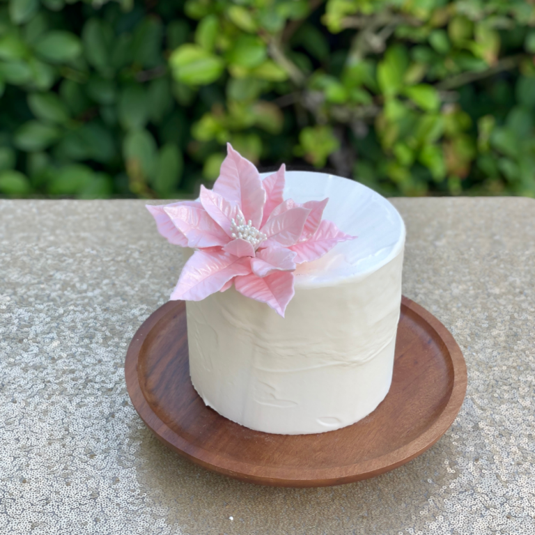 blush pink poinsettia sugar flower for christmas by kelsie cakes
