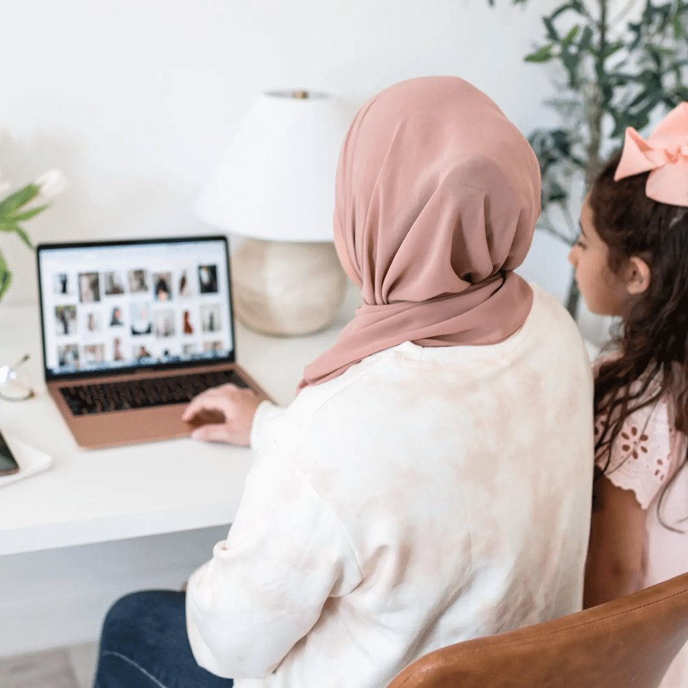 woman sitting at computer with her daughter