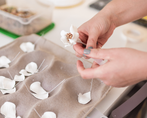 Sugar Artist assembling petals of a sugar flower, which is a simple way how to repair a damaged Sugar Flower