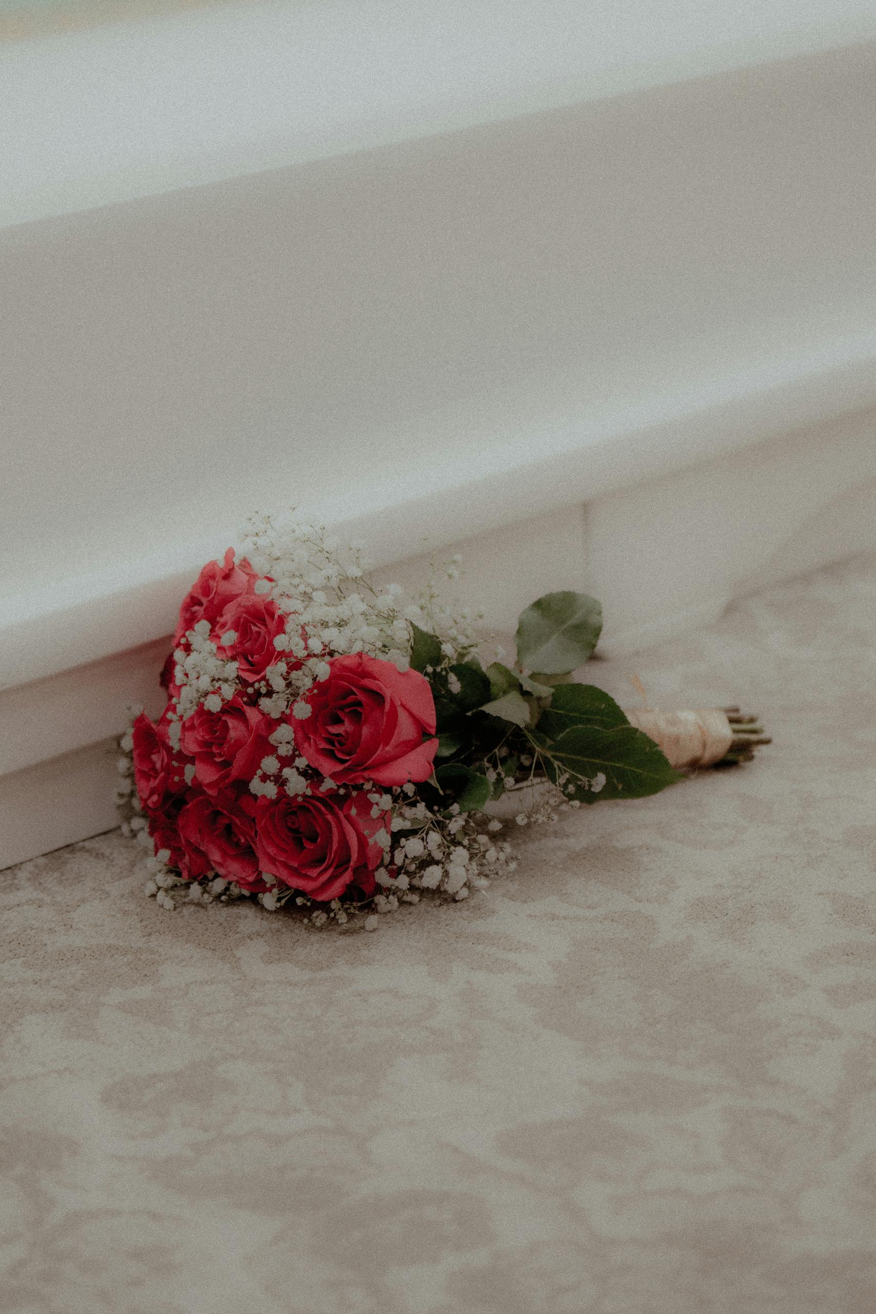 Close-up of a Bouquet of Pink Roses Lying on the Floor